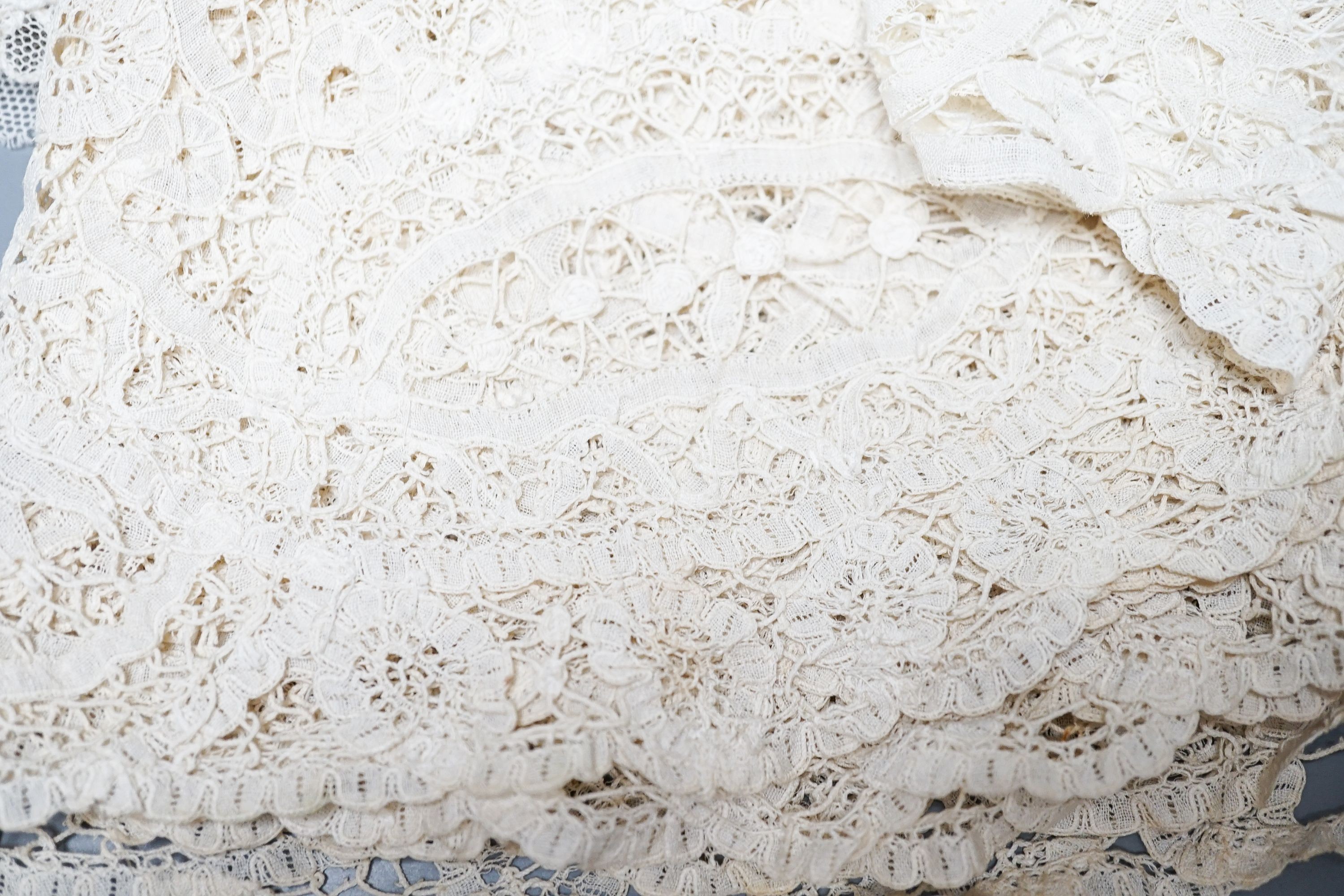 A large tape lace 'Bertha', various hand made laces, lengths of needle run laces, a skirt panel etc.
